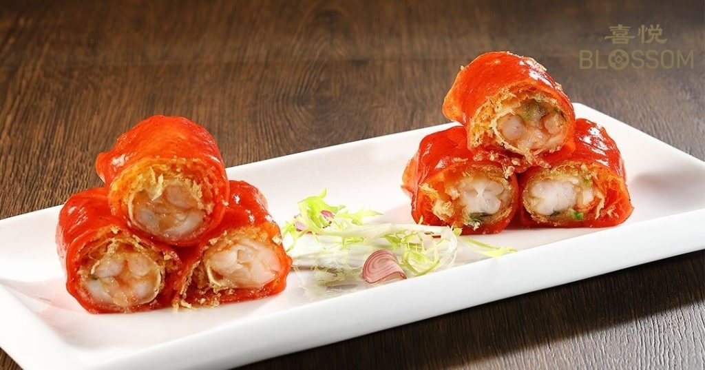 Crispy prawn red rice rolls from Blossom Restaurant on a white plate