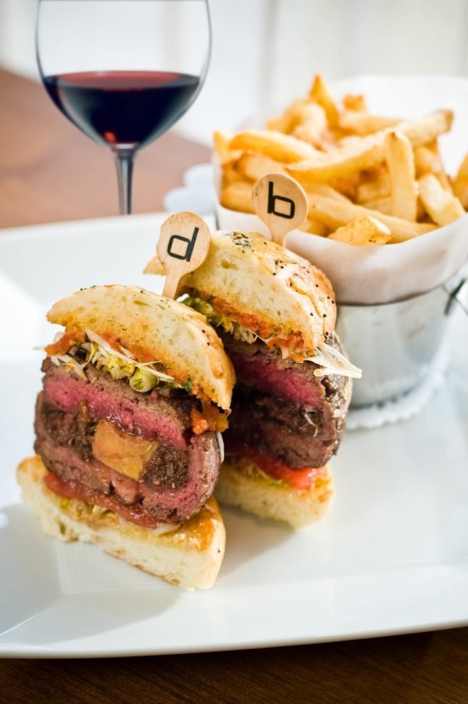 The Original db Burger from db Bistro & Oyster Bar, served with fries and red wine