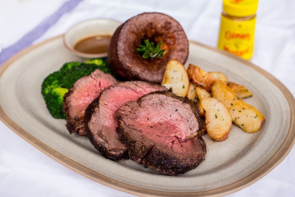 A classic roast beef dinner from The Queen & Mangosteen, served on an oval plate.