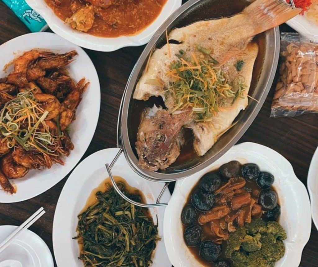 A table spread with various seafood dishes from AA Badok's Seafood