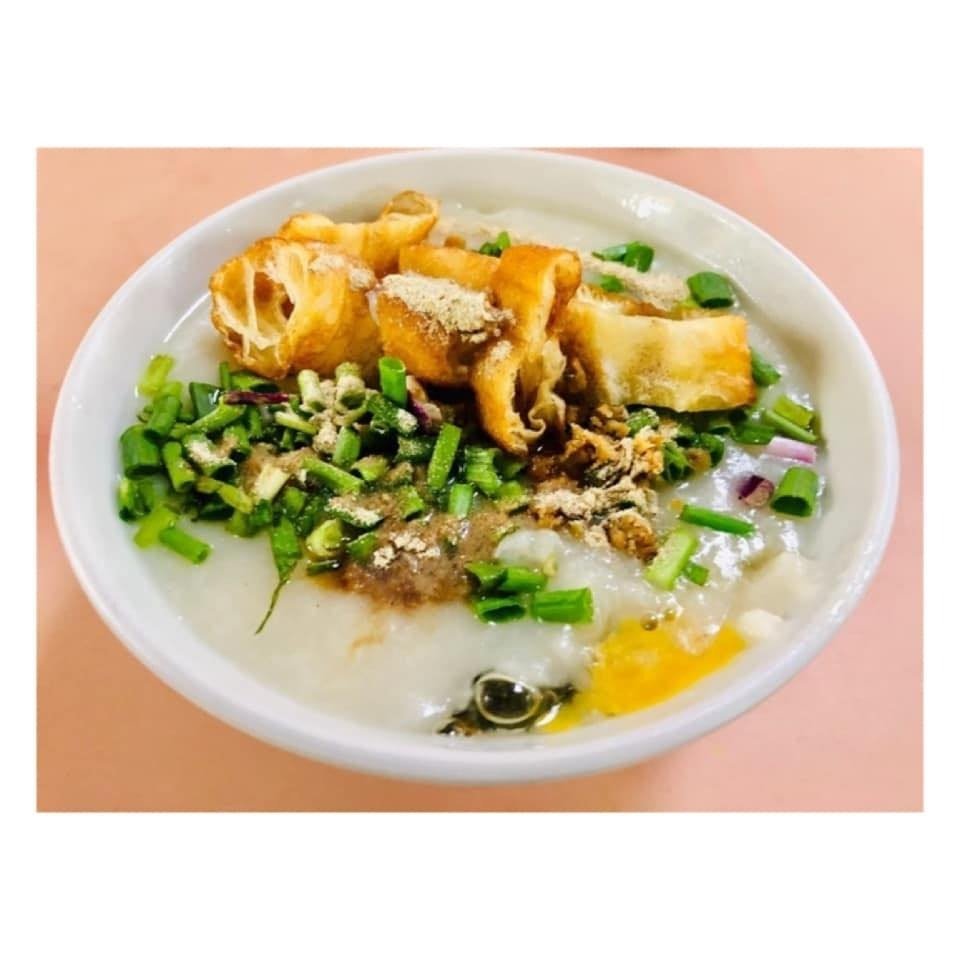 Top-down view of a white bowl filled with Chai Chee Pork Porridge