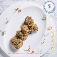 Chef Chan's Steamed Iberico Pork Ribs with Jasmine Rice Powder, garnished and served on a white plate.