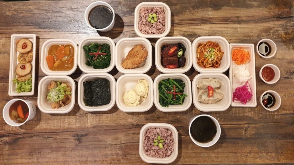 Overhead view of an extensive Korean meal spread from Daehwa Restaurant