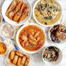 Overhead view of a colorful spread of various Southeast Asian dishes