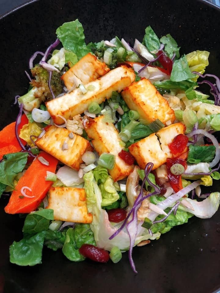 Close-up of a vibrant salad from Fat Saigon Boy, served in a black bowl