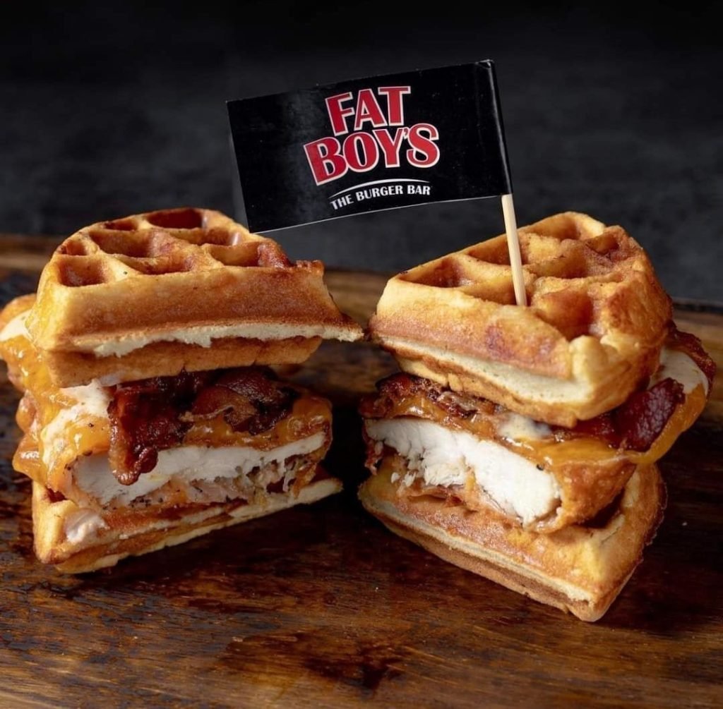 Close-up of a chicken and waffle sandwich from Fat Boys The Burger Bar