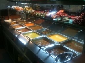 Buffet display at Jaggi’s Northern Indian Cuisine, showcasing a variety of North Indian dishes in heated serving trays.