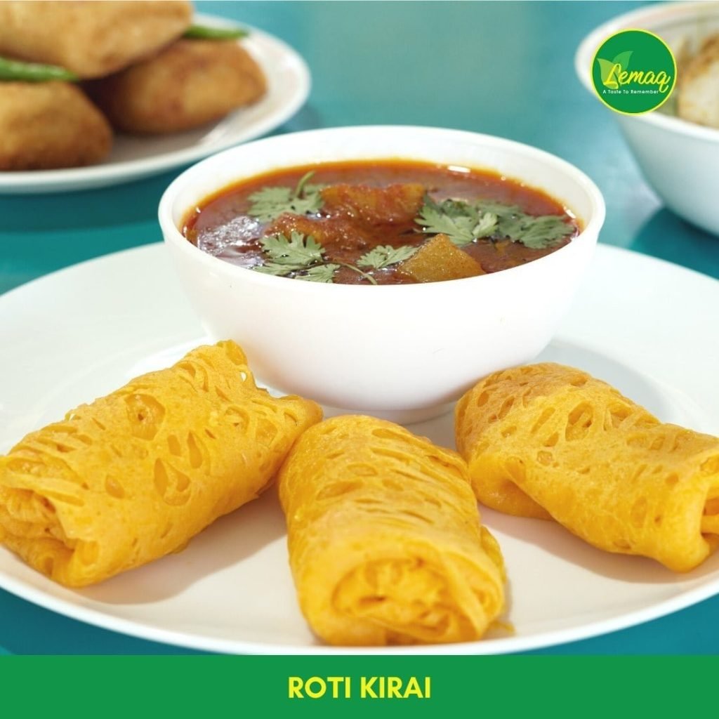Lemaq's Roti Kirai: three delicate, lacy, rolled net crepes served with a side of rich red curry, ready to eat