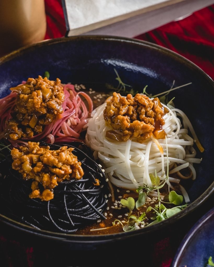 Close-up of an artfully presented bowl of three types of noodles