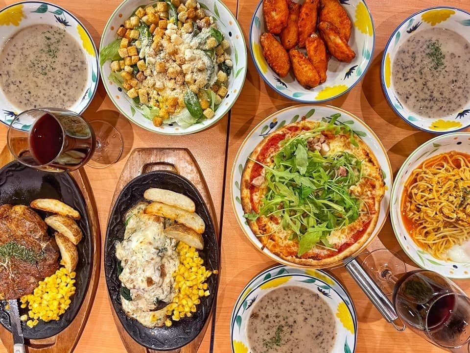 Overhead view of a wooden table laden with a Western-style feast