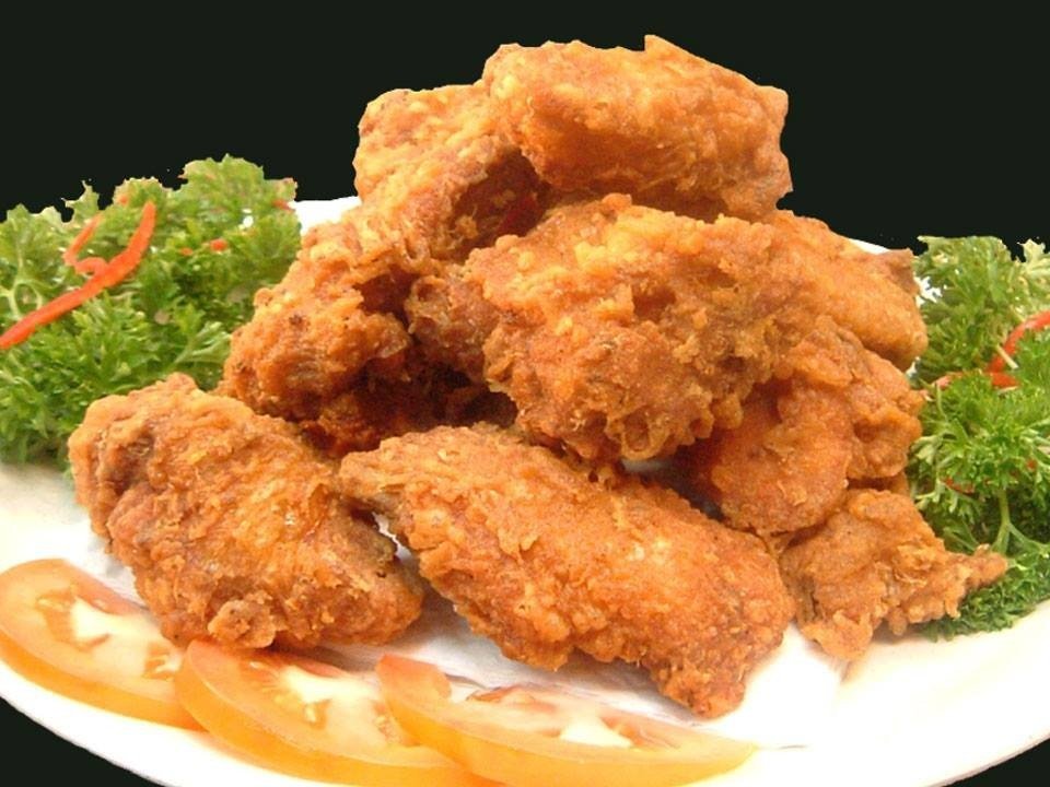 A generous pile of golden-brown, crispy fried chicken pieces