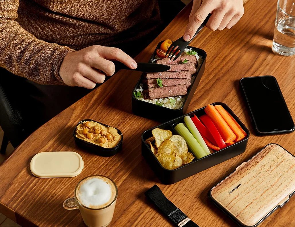 person eating a meal from a w&p porter bowl on a wooden table