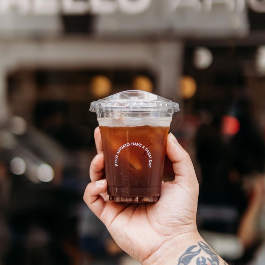 a man holding Hello Arigato Iced Coffee