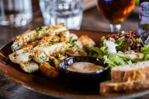 seafood dish with creamy sauce and salad