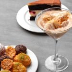 A delicious spread of various desserts on a grey table