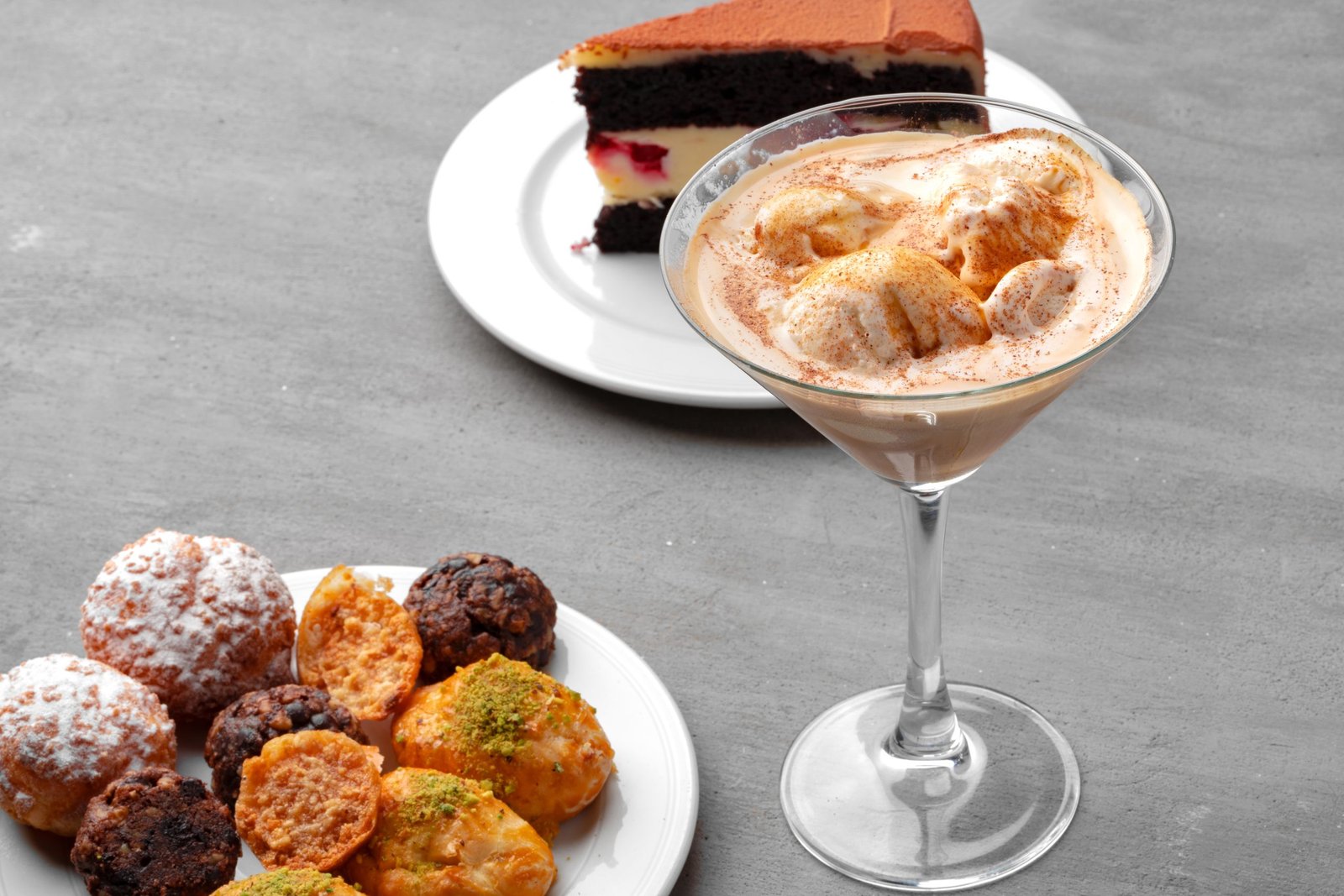 A delicious spread of various desserts on a grey table
