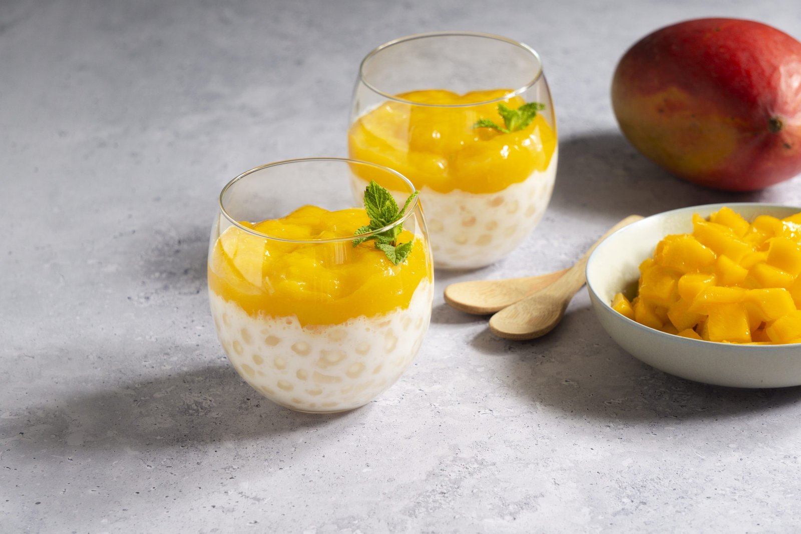 Two glasses of creamy mango sago pudding