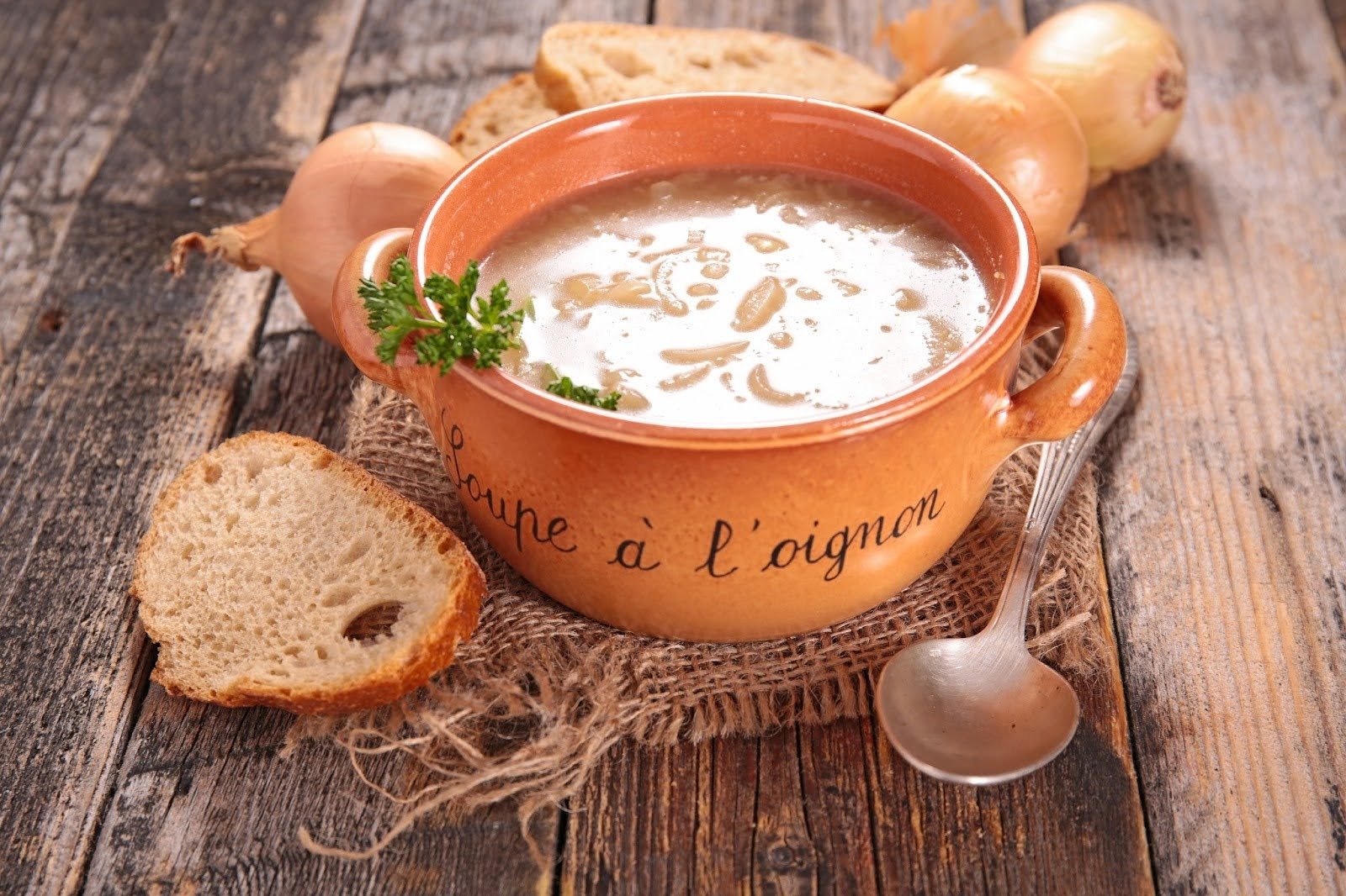 A rustic bowl of French onion soup with crusty bread