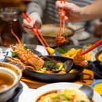 An appetizing, close-up shot of a communal Chinese seafood feast.