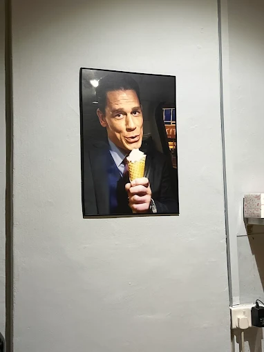 A poster of John Cena eating an ice cream cone