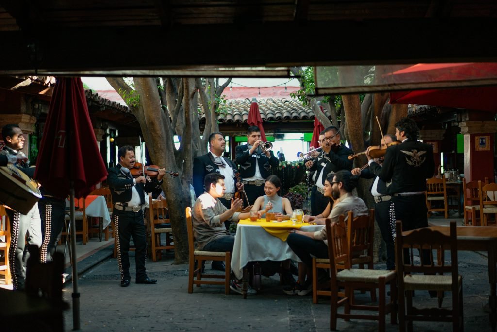 a group of diners enjoying mexican music at a restaurant