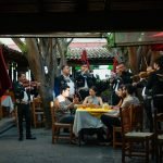 a group of diners enjoying mexican music at a restaurant