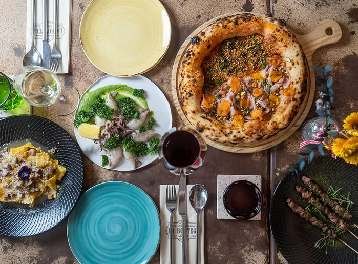 A variety of handmade Italian pastas served alfresco, including tortelli with sage butter, orecchiette with broccoli and sausage, and classic spaghetti carbonara