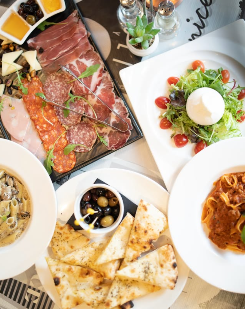 A variety of handmade Italian pasta dishes served outdoors at Rosso Vino