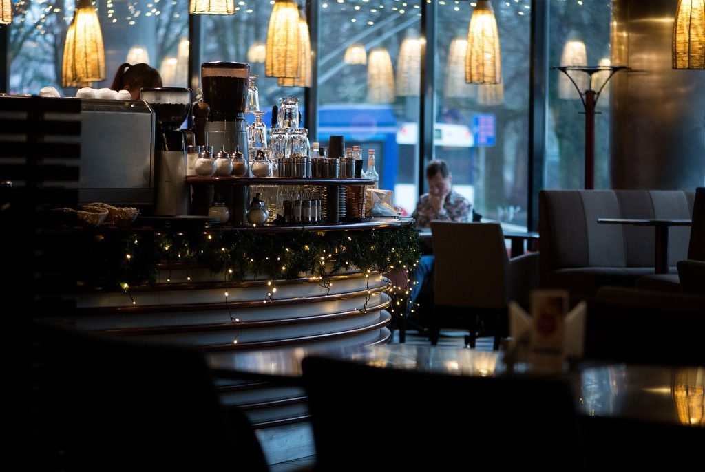 dimly lit cafe with twinkle lights decorating the counter