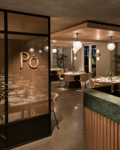 Po Restaurant dining room at The Warehouse Hotel Singapore with round tables and warm lighting